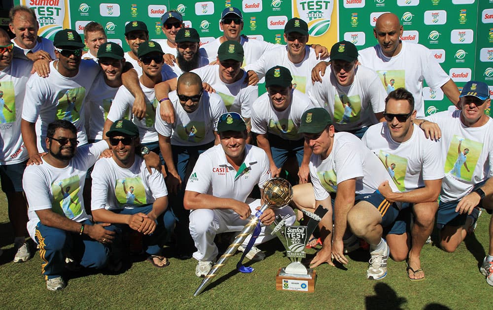 South Africa players and team members pose for photographers after winning the cricket test series against India at Kingsmead stadium, Durban, South Africa.