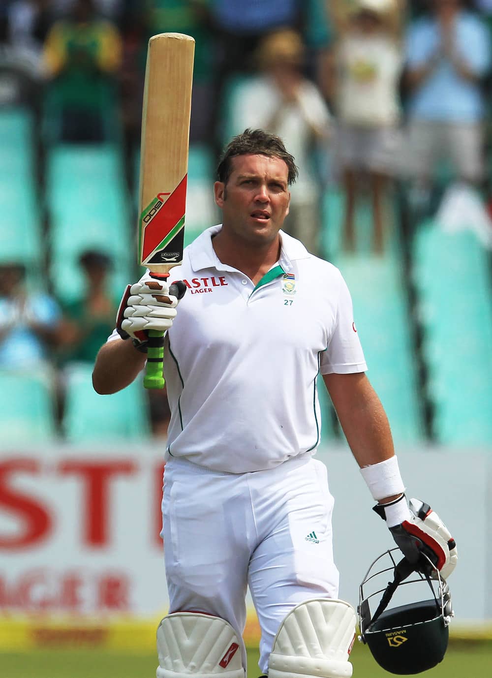 South Africa's batsman Jacques Kallis raises his bat after reaching a half century on the third day of their cricket test match against India at Kingsmead stadium.