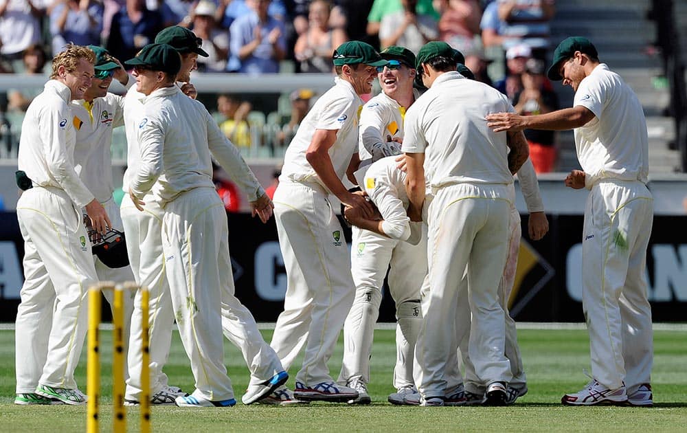 Australian players celebrate the wicket of England's Stuart Broad off the bowling of Nathan Lyon during their Ashes cricket test match.