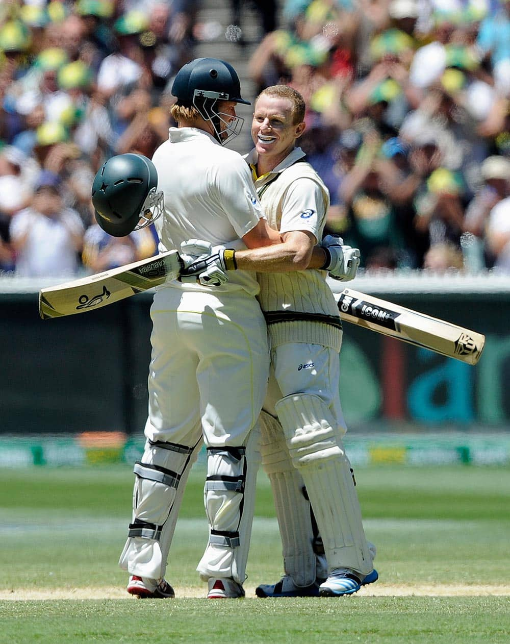 Australia's Shane Watson, left, congratulates Chris Rogers on making 100 runs against England during their Ashes cricket test match.