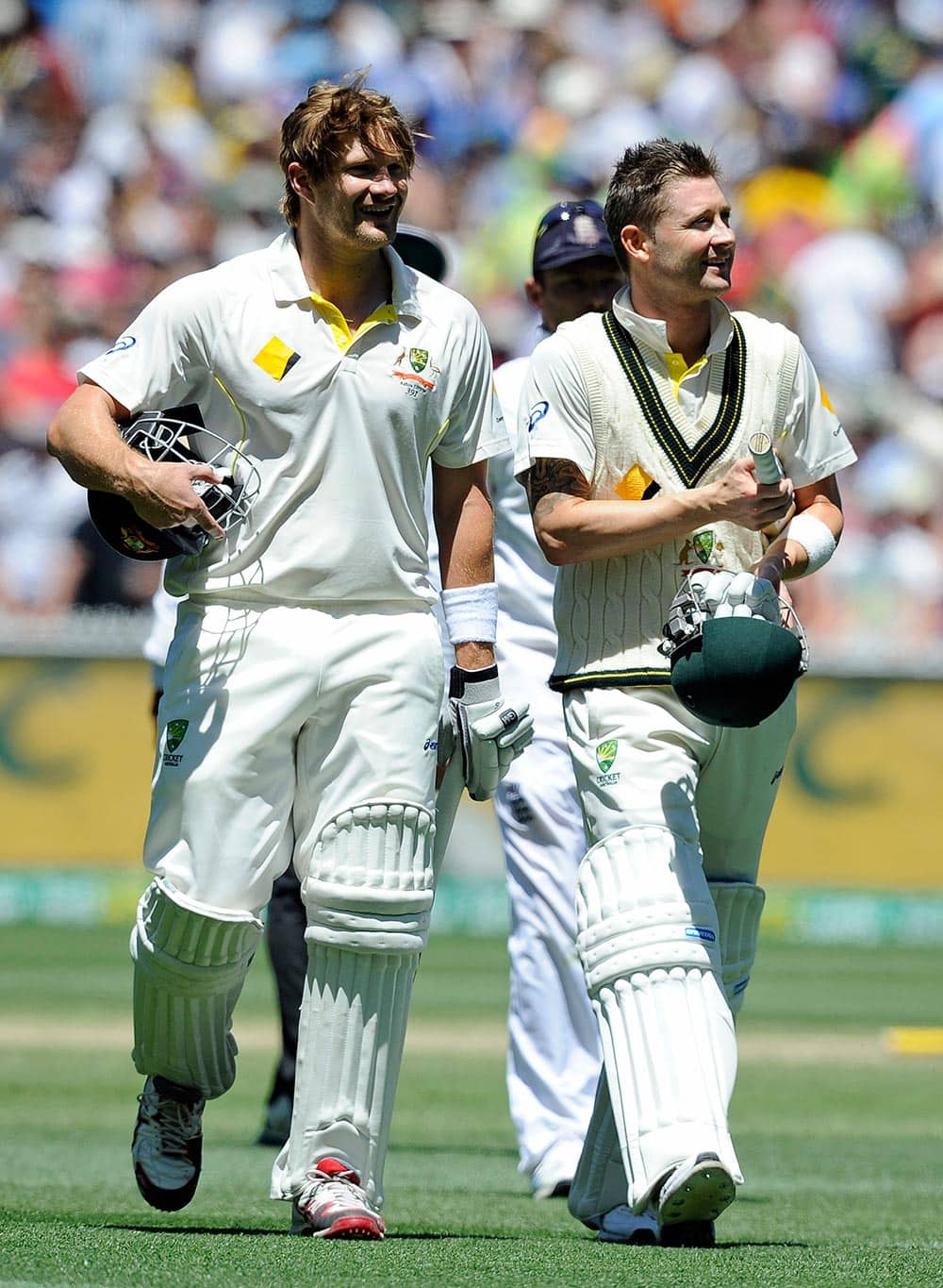 Australia's Shane Watson, left, and Michael Clarke walk off the field after defeating England in their Ashes cricket test match.