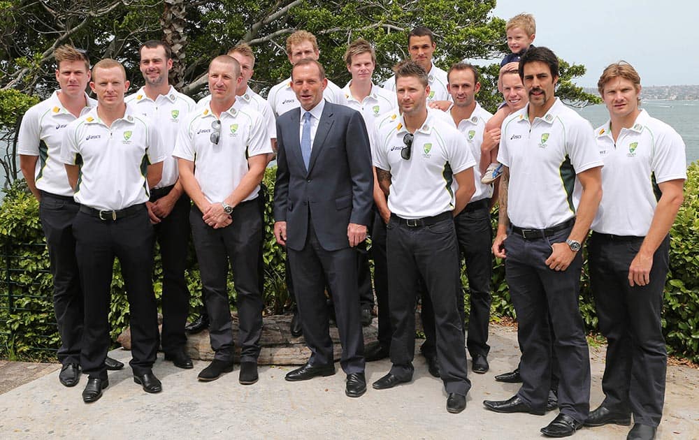 Australian cricket team members poses for a photo with Australia's Prime Minister Tony Abbott, during a New Year's Day reception at Kirribilli House in Sydney, Australia. Australia and England play in the Sydney Ashes test match on Friday, Jan. 3, 2014.