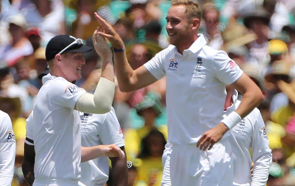 England cricket players Ben Stokes, left, and Stuart Broad celebrate for taking the wicket of Australia's George Bailey during their Ashes cricket test match against Australia in Sydney.