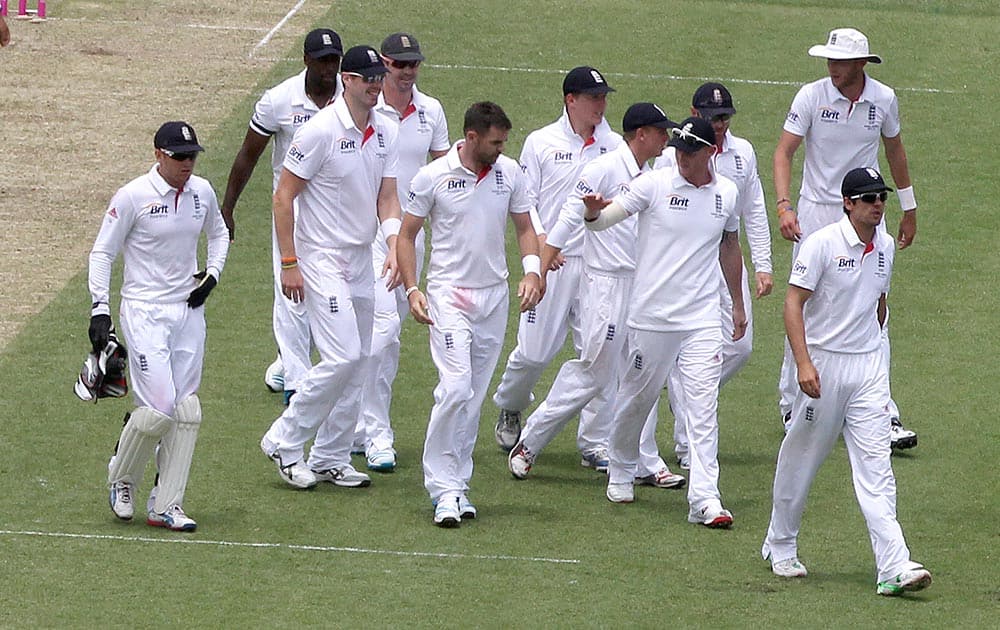 England cricket captain Alastair Cook, front right, leads his team off the field during their Ashes cricket test match against Australia in Sydney.