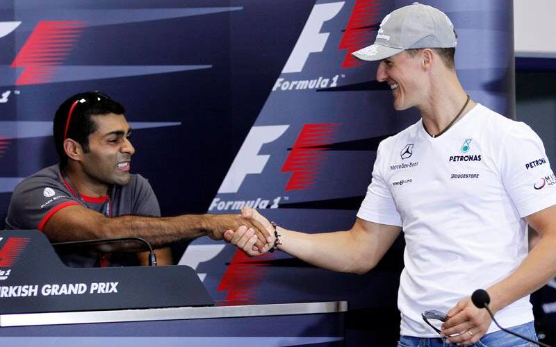 Mercedes Grand Prix driver Michael Schumacher of Germany, shakes hand with HRT driver Karun Chandhok of India during a news conference ahead of the Turkish Formula One Grand Prix at the Istanbul Park circuit racetrack, in Istanbul in May 2010.