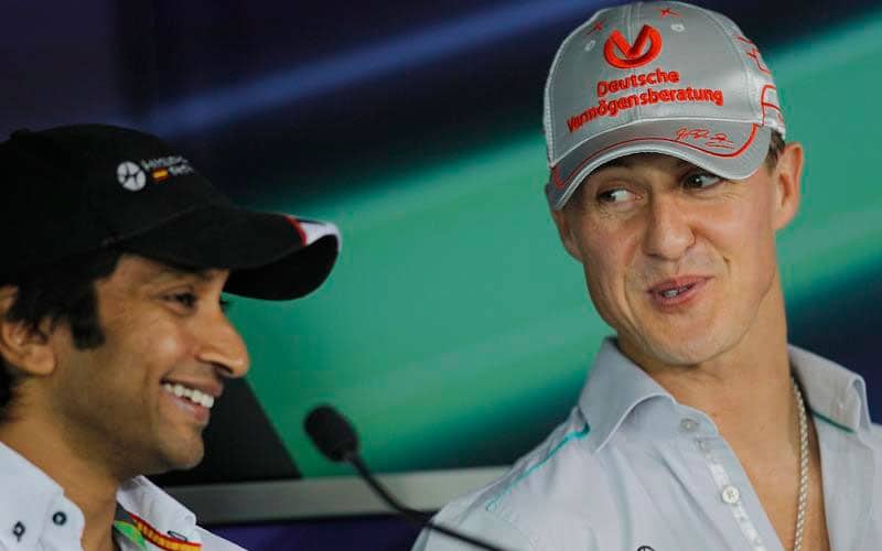 Hispania Racing Team driver Narain Karthikeyan of India, left, and Mercedes driver Michael Schumacher of Germany, right, speak during the driver's press conference of the Indian Formula One Grand Prix at the Buddh International Circuit in Noida, 38 kilometers (24 miles) from New Delhi.