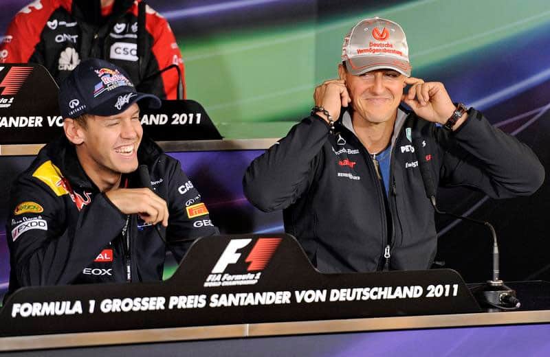 Mercedes Grand Prix driver Michael Schumacher of Germany, right, reacts next to Red Bull driver Sebastian Vettel of Germany, left, during a press conference prior the upcoming Formula One German Grand Prix at the Nuerburgring circuit, Nuerburg, Germany in July 2011.