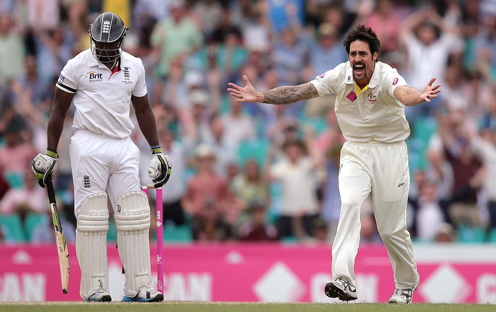 England's Michael Carberry, left, stands his ground as Australia's Mitchell Johnson appeals for a LBW decision on Carberry in their Ashes cricket test match at the Sydney Cricket Ground in Sydney.