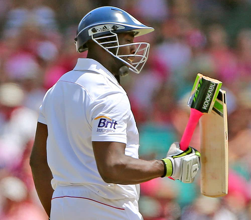 England's Michael Carberry looks at his broken bat on the third day of their Ashes cricket test match against Australia in Sydney.