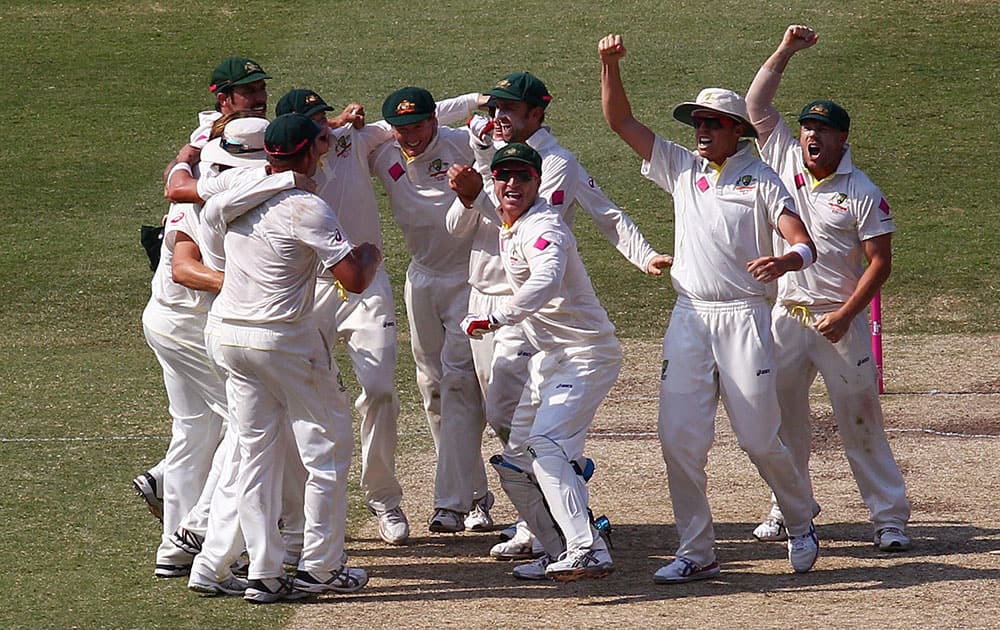 The Australian cricket team gathers in the wicket to begin their celebrations after their victory over England on day 3 of their Ashes cricket test match at the Sydney Cricket Ground in Sydney.