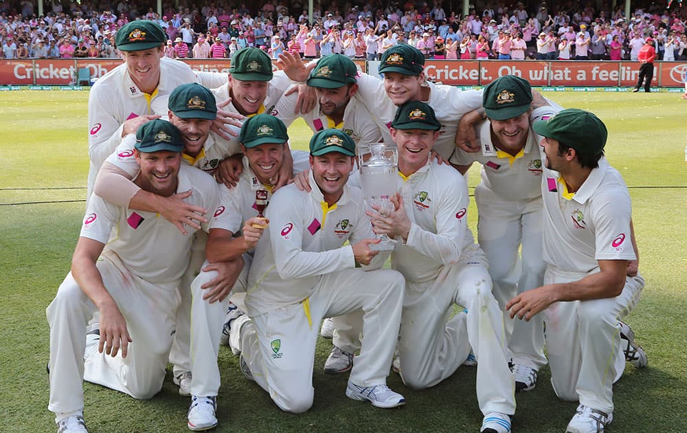 Australian players pose with their trophy after winning their Ashes cricket series against England in Sydney. Australia won the series 5-0.