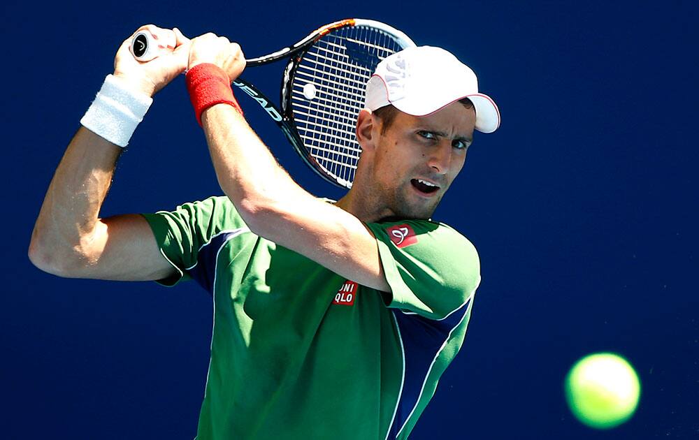 Novak Djokovic of Serbia makes a backhand return during a training session ahead of the Australian Open tennis championship.