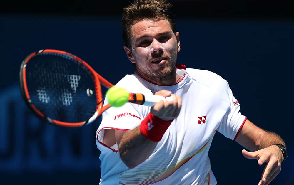 Stanislas Wawrinka of Switzerland makes a forehand return to Andrey Golubev during their first round match at the Australian Open tennis championship in Melbourne.