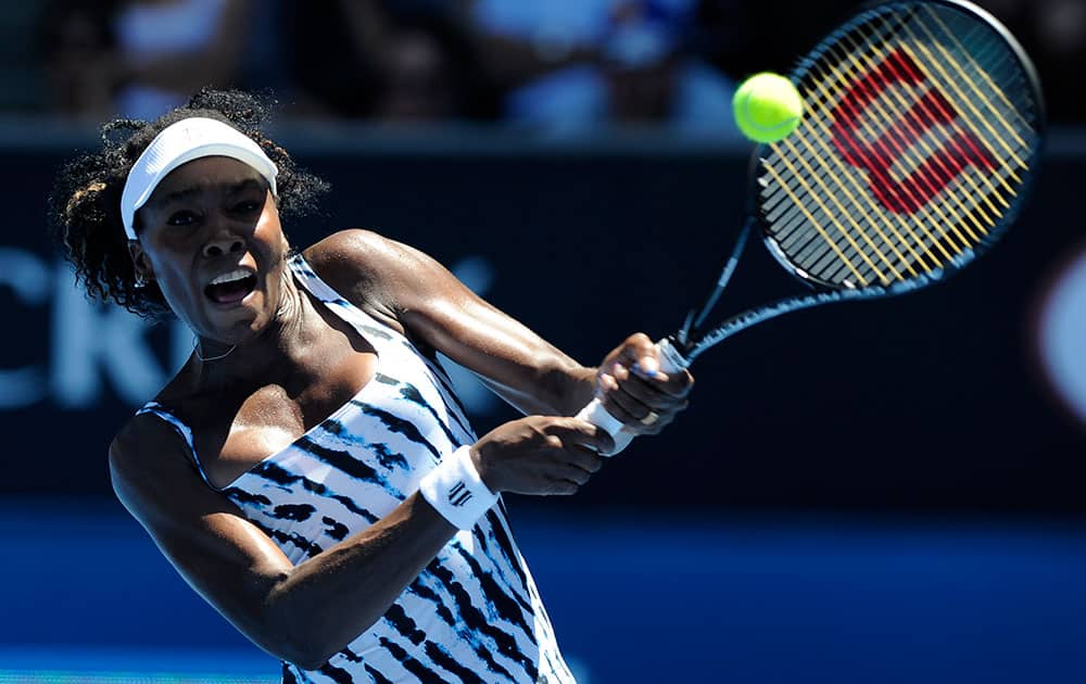 Venus Williams of the US makes a backhand return during her first round match against Ekaterina Makarova of Russia at the Australian Open tennis championship in Melbourne.