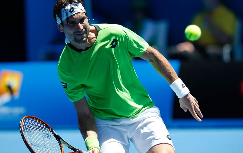 David Ferrer of Spain makes a forehand return to Alejandro Gonzalez of Colombia during their first round match at the Australian Open tennis championship in Melbourne.