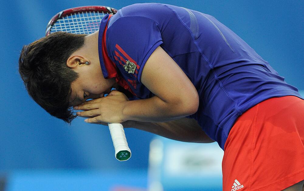 Luksika Kumkhum of Thailand bows to the crowd as she celebrates after defeating Petra Kvitova of the Czech Republic during their first round match at the Australian Open tennis championship in Melbourne, Australia.