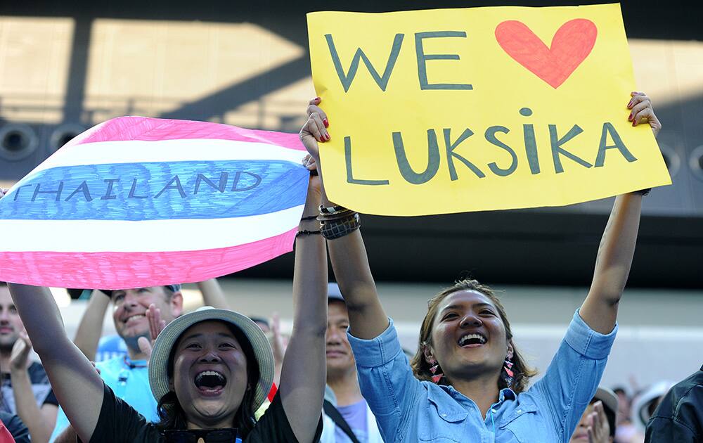 Supporters of Luksika Kumkhum of Thailand cheer her on during her first round win over Petra Kvitova of the Czech Republic at the Australian Open tennis championship in Melbourne, Australia.