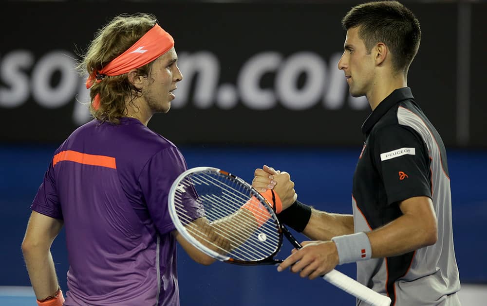 Novak Djokovic of Serbia is congratulated by Lukas Lacko of Slovakia after winning their first round match at the Australian Open tennis championship in Melbourne, Australia.