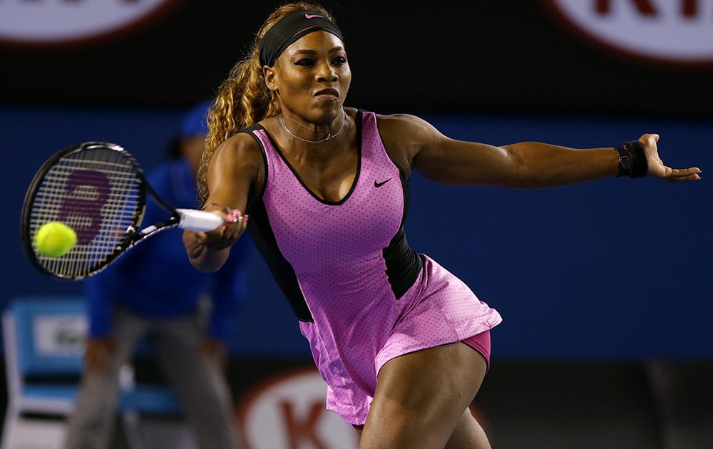 Serena Williams of the United States hits a forehand return to Ashleigh Barty of Australia during their first round match at the Australian Open tennis championship in Melbourne, Australia.