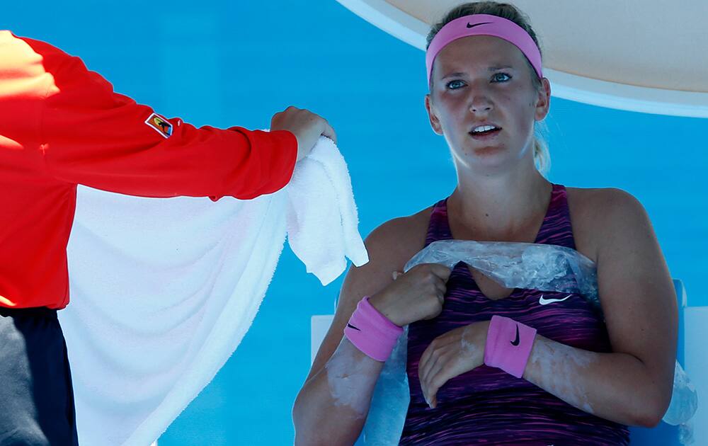 Victoria Azarenka of Belarus holds an ice pack around her during a break in her first round match against Johanna Larsson of Sweden at the Australian Open tennis championship in Melbourne, Australia.