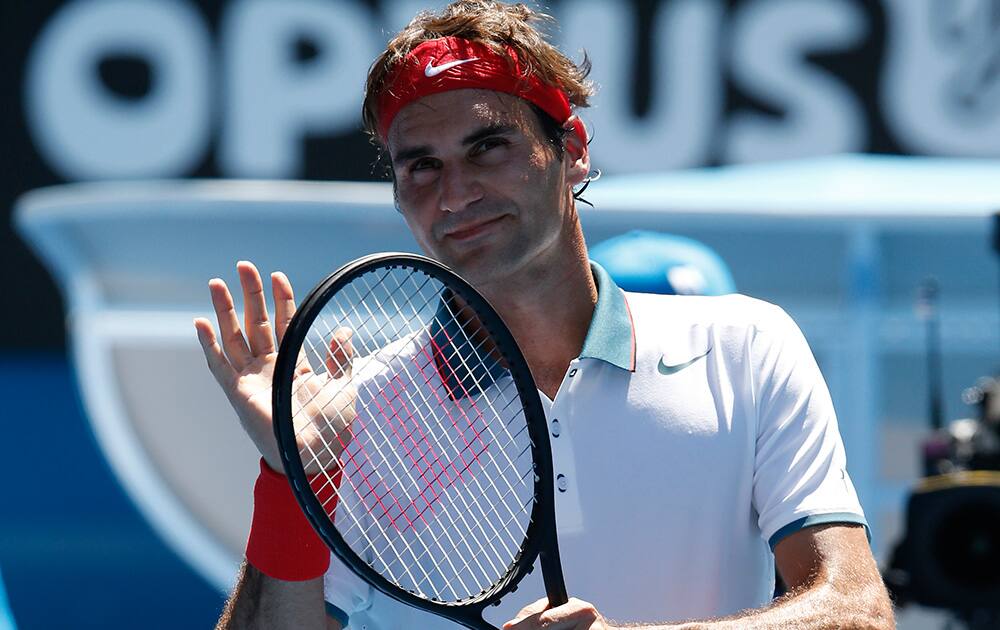 Roger Federer of Switzerland celebrates his win over James Duckworth of Australia after their first round match at the Australian Open tennis championship in Melbourne, Australia.