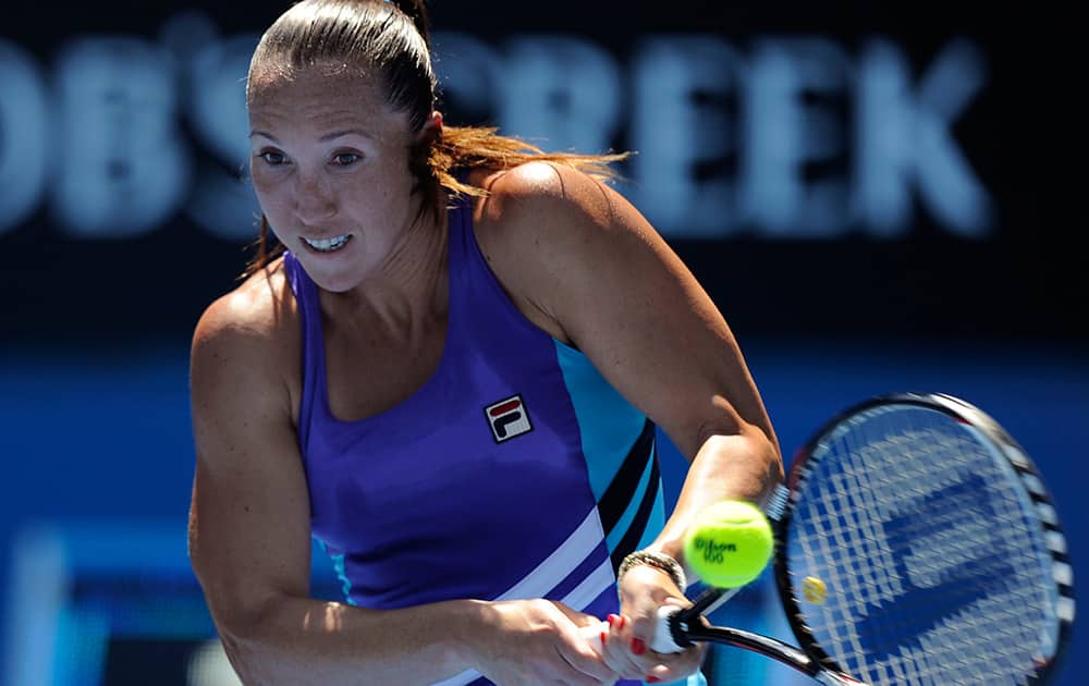 Jelena Jankovic of Serbia makes a backhand return to Misaki Doi of Japan during their first round match at the Australian Open tennis championship in Melbourne, Australia.