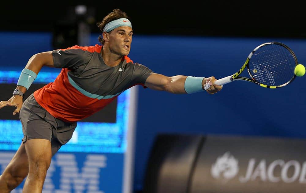 Rafael Nadal of Spain makes a forehand return to Bernard Tomic of Australia during their first round match at the Australian Open tennis championship in Melbourne, Australia.