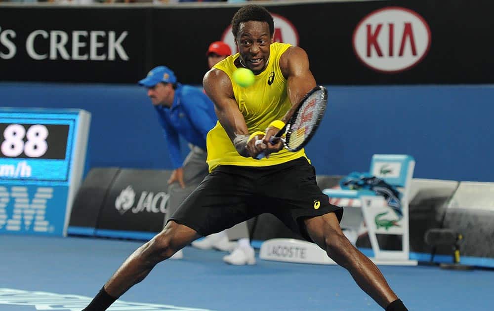 Gael Monfils of France makes a backhand return to Ryan Harrison of the U.S. during their first round match at the Australian Open tennis championship in Melbourne, Australia.