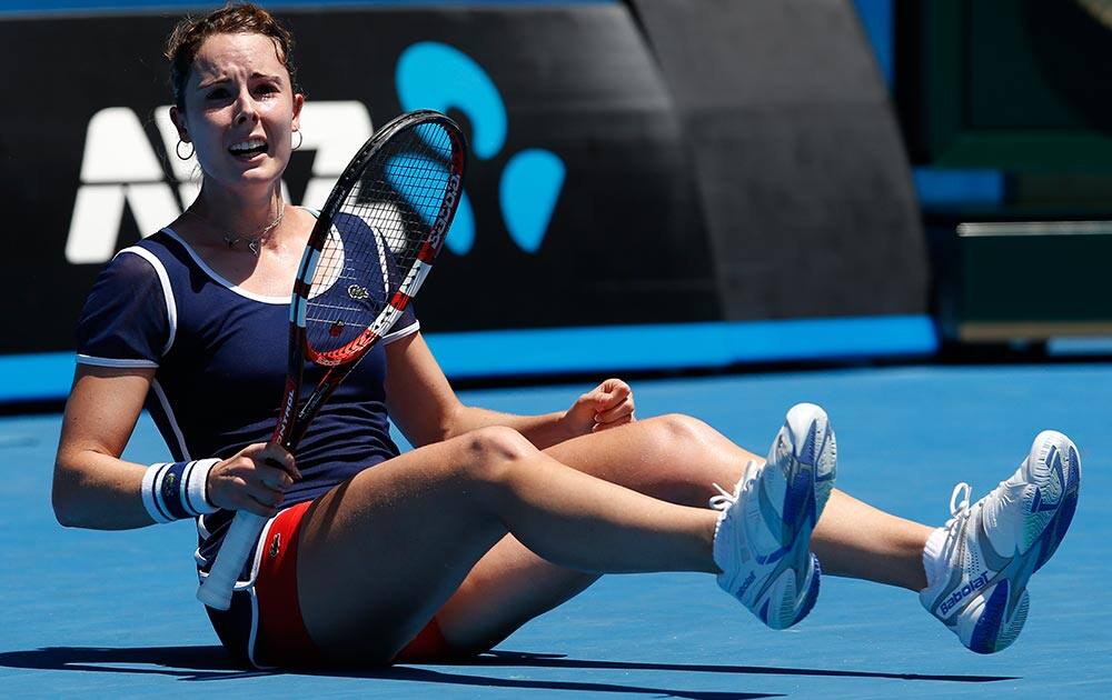 Alize Cornet of France celebrates after winning her second round match against Camila Giorgi of Italy at the Australian Open tennis championship in Melbourne, Australia.
