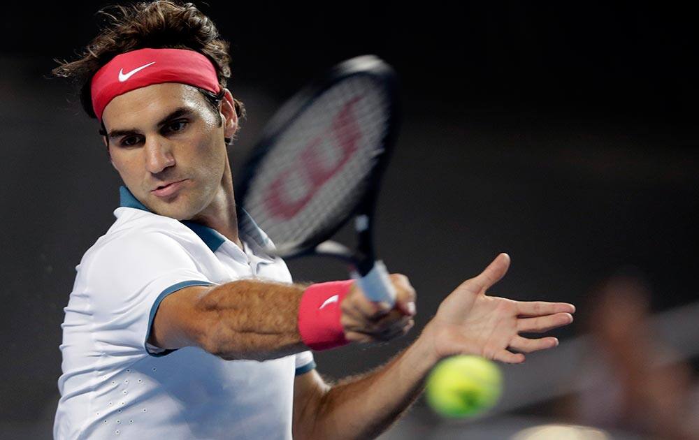 Roger Federer of Switzerland hits a forehand return to Blaz Kavcic of Slovenia during their second round match at the Australian Open tennis championship in Melbourne, Australia.