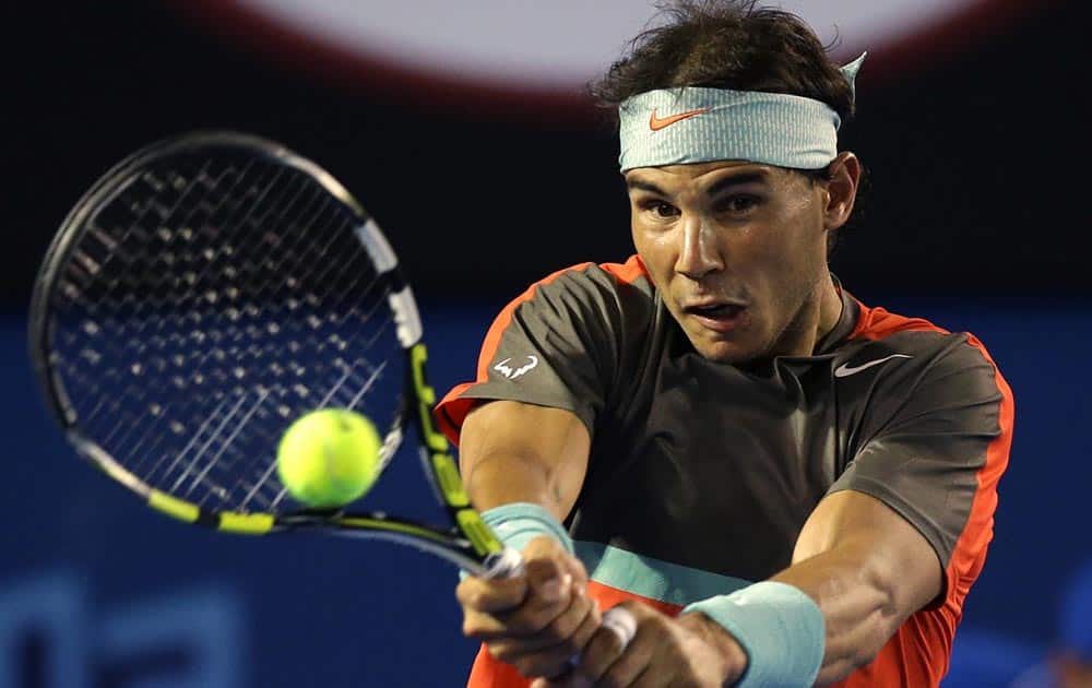 Rafael Nadal of Spain makes a backhand return to Thanasi Kokkinakis of Australia during their second round match at the Australian Open tennis championship in Melbourne, Australia.