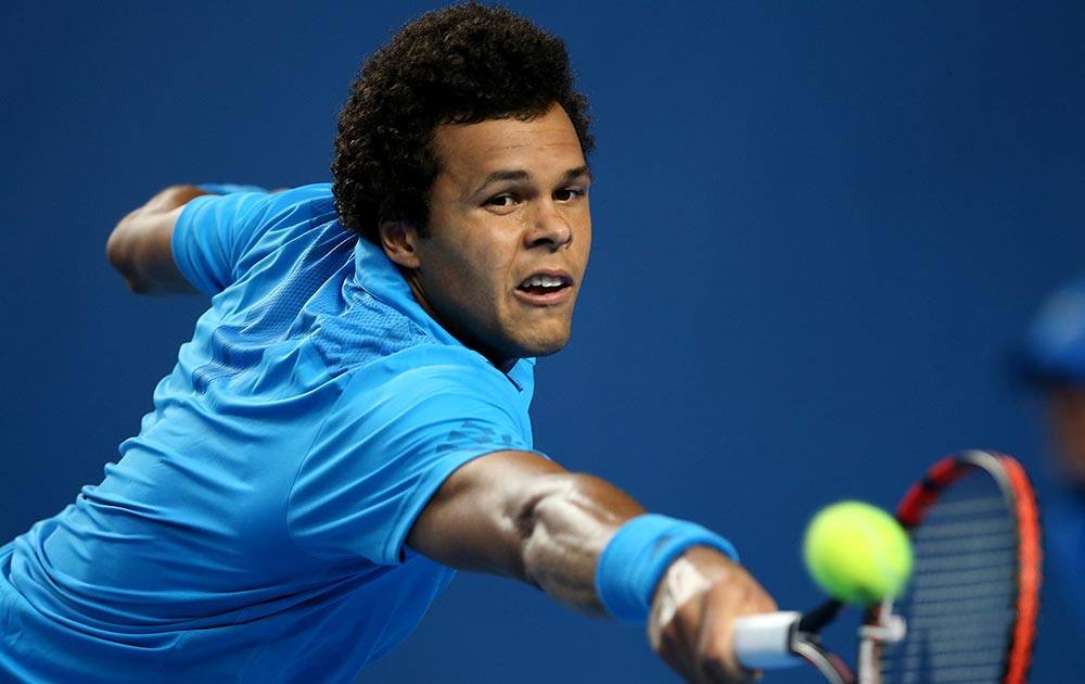 Jo-Wilfried Tsonga plays a backhand return to compatriot Gilles Simon of France during their third round match at the Australian Open tennis championship in Melbourne, Australia.