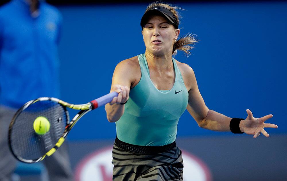 Eugenie Bouchard of Canada makes a forehand return to Casey Dellacqua of Australia during their fourth round match at the Australian Open tennis championship in Melbourne.