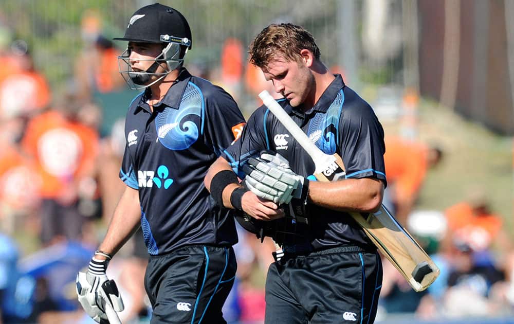 New Zealand's Tim Southee, and Corey Anderson, 68 not out, walk off at the end of their innings of 292 against India in their first one day international cricket match at McLean Park in Napier.