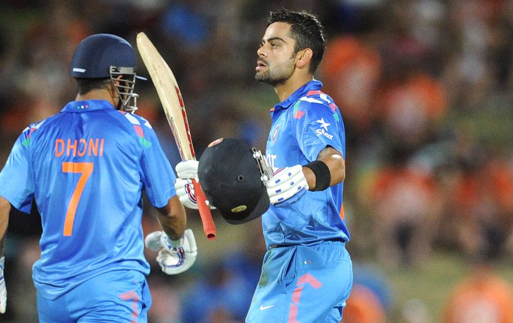 Virat Kohli, celebrates his century against New Zealand in their first one day international cricket match at McLean Park in Napier.
