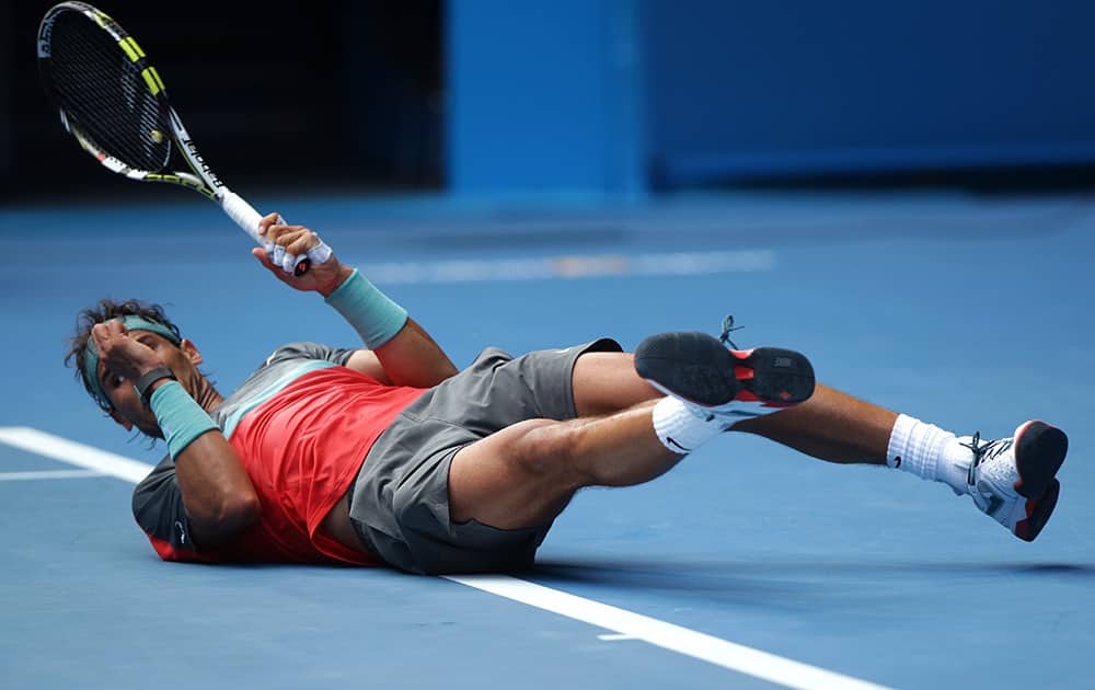Rafael Nadal of Spain falls as he plays Kei Nishikori of Japan during their fourth round match at the Australian Open tennis championship in Melbourne, Australia.