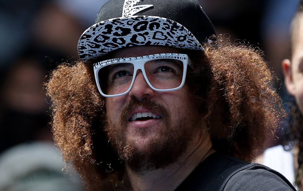 Music artist Redfoo watches his girlfriend Victoria Azarenka of Belarus play Sloane Stephens of the U.S. during their fourth round match at the Australian Open tennis championship in Melbourne, Australia.