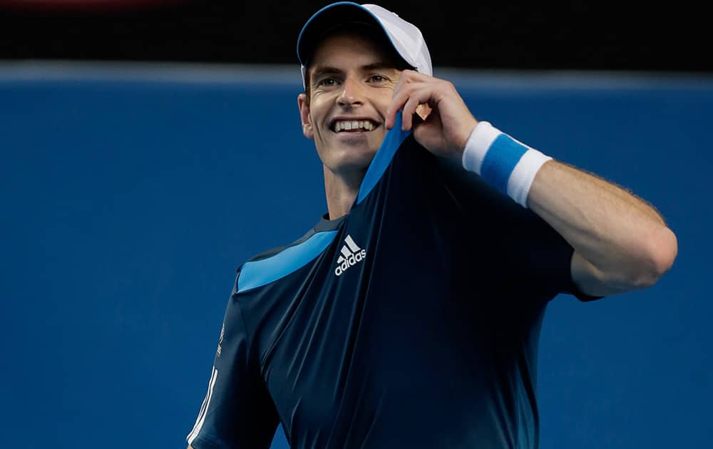 Andy Murray of Britain holds up his shirt during his fourth round match against Stephane Robert of France at the Australian Open tennis championship in Melbourne, Australia.