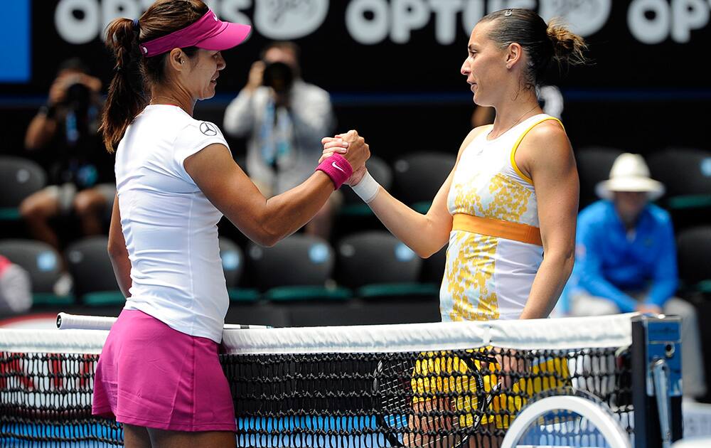 Li Na of China, left, shakes hands with Flavia Pennetta of Italy at the net, after Li won their quarterfinal at the Australian Open tennis championship in Melbourne, Australia.
