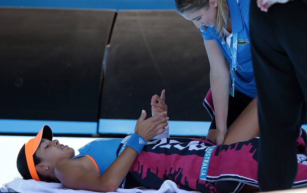 Ana Ivanovic of Serbia receives a medical treatment as she plays Eugenie Bouchard of Canada during their quarterfinal at the Australian Open tennis championship in Melbourne, Australia.