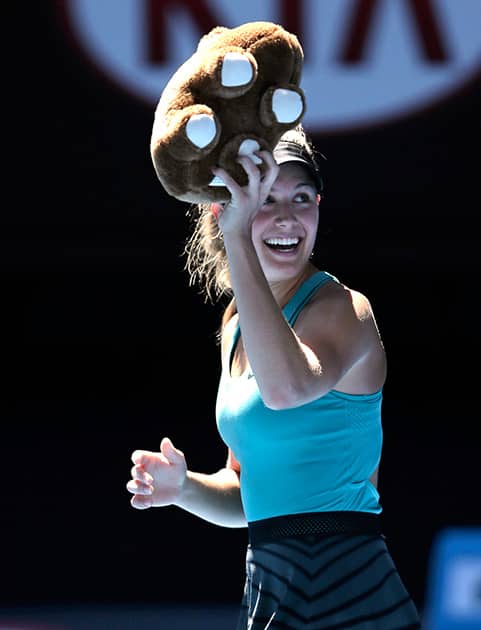 Eugenie Bouchard of Canada, holding stuffed animal of wombat, celebrates after defeating Ana Ivanovic of Serbia during their quarterfinal at the Australian Open tennis championship in Melbourne, Australia.