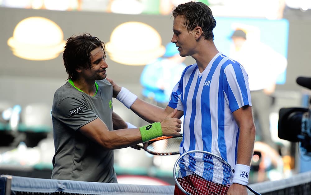 Tomas Berdych of the Czech Republic, right, shakes hands with David Ferrer of Spain at the net, after his win in their quarterfinal at the Australian Open tennis championship in Melbourne, Australia.