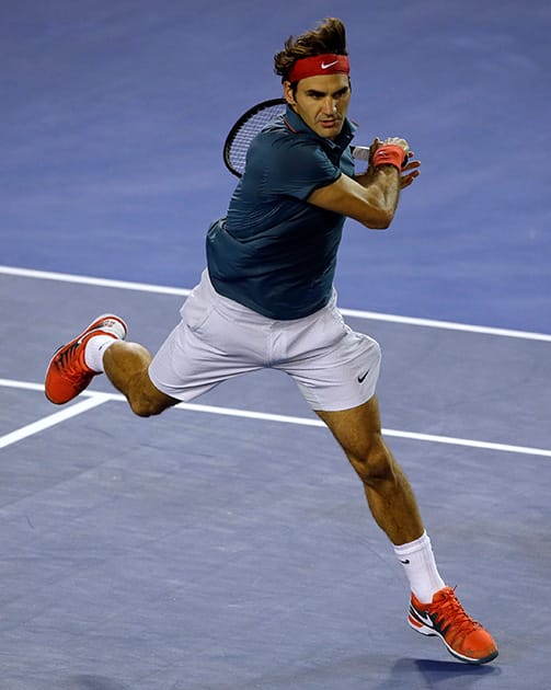 Roger Federer of Switzerland makes a backhand shot to Jo-Wilfried Tsonga of France during their fourth round match at the Australian Open tennis championship in Melbourne, Australia.