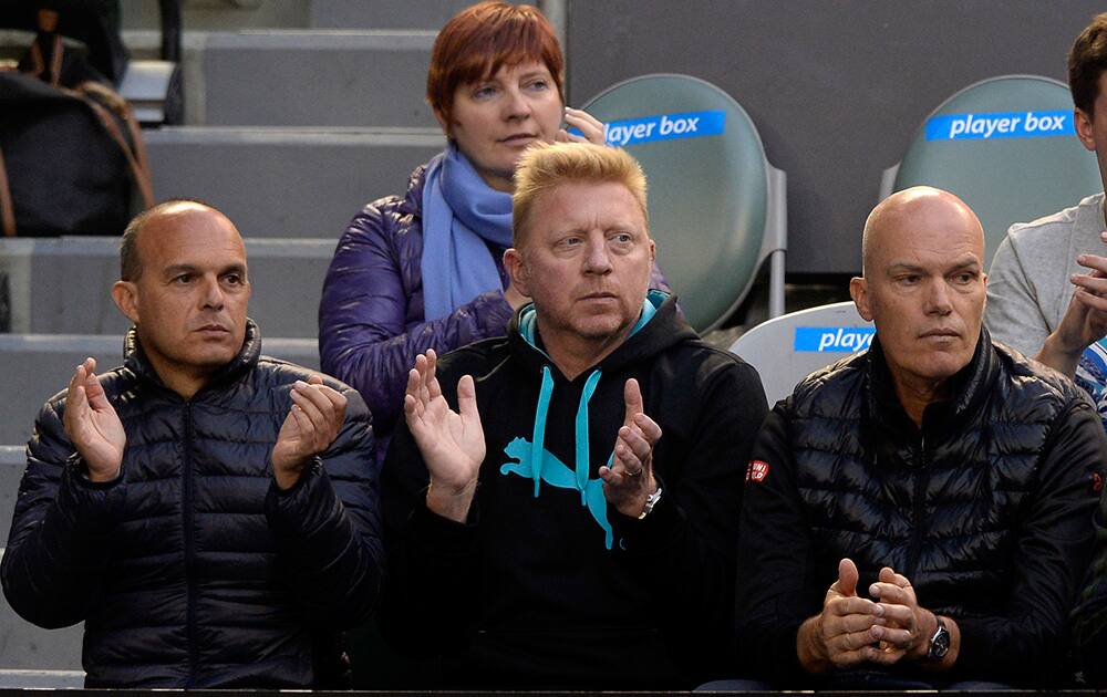 Boris Becker, center, former Grand Slam champion and coach of Novak Djokovic, watches Djokovic's quarterfinal against Stanislas Wawrinka of Switzerland at the Australian Open tennis championship in Melbourne, Australia.