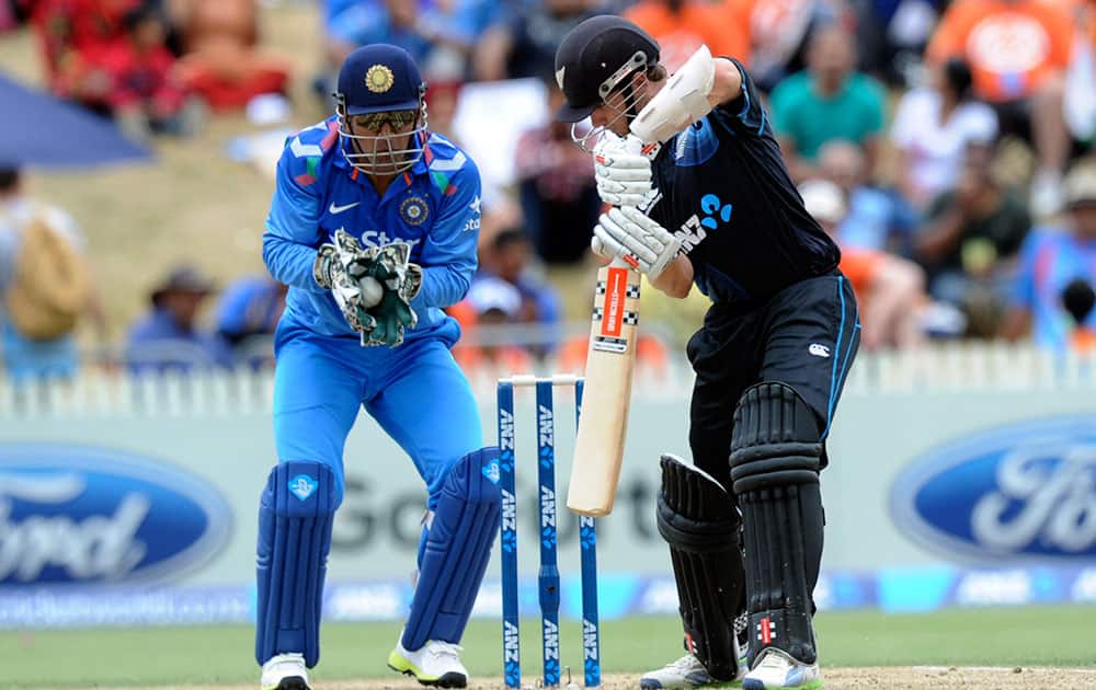 India’s MS DhonIndia, left, gloves the ball after New Zealand's Kane Williamson played and missed in the second one-day International cricket match at Seddon Park in Hamilton, New Zealand.