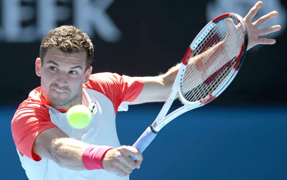 Grigor Dimitrov of Bulgaria makes a backhand return to Rafael Nadal of Spain during their quarterfinal at the Australian Open tennis championship in Melbourne, Australia.