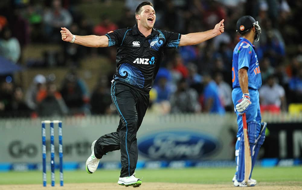 New Zealand's Mitchell McClenaghan celebrates the wicket of India’s Ajinkya Rahane for 36 during their second one-day international cricket match, at Seddon Park, in Hamilton, New Zealand.