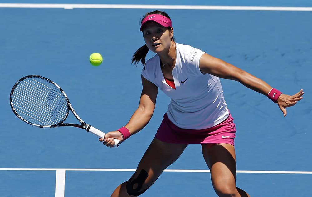 Li Na of China looks at a ball for a volley to Eugenie Bouchard of Canada during their semifinal at the Australian Open tennis championship in Melbourne, Australia.