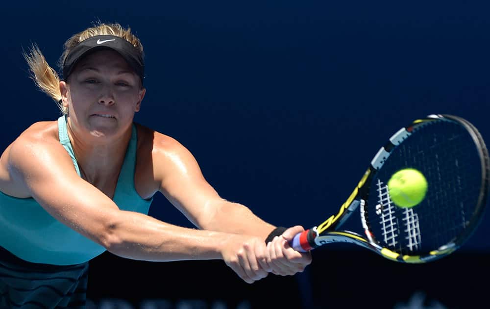 Eugenie Bouchard of Canada makes a backhand return to Li Na of China during their semifinal at the Australian Open tennis championship in Melbourne, Australia.