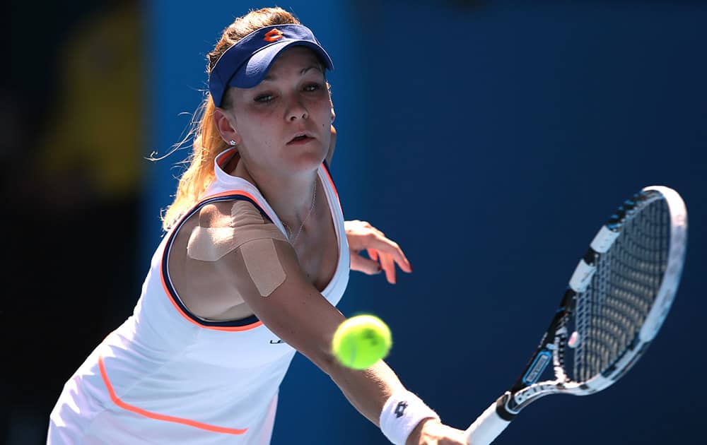 Agnieszka Radwanska of Poland makes a backhand return to Dominika Cibulkova of Slovakia during their semifinal at the Australian Open tennis championship in Melbourne.